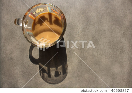 Silhouette from a thicket with coffee on a stone surface 49608857