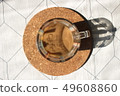 A cup of coffee with milk on a cork base 49608860