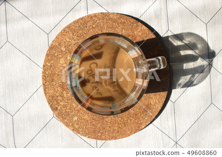 A cup of coffee with milk on a cork base 49608860