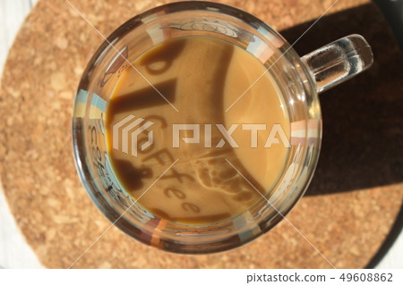 A cup of coffee with milk on a cork base 49608862