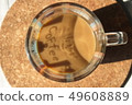 A cup of coffee with milk on a cork base 49608889