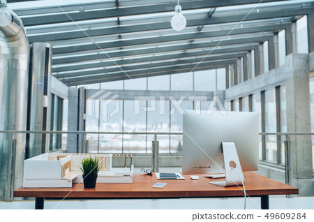 An interior of a desk with computer in modern spacious office. An interior of a desk with computer in modern spacious office. 49609284