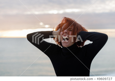 Young woman with red hair 49609727