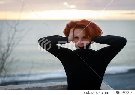 Portrait of a young woman with red hair 49609729