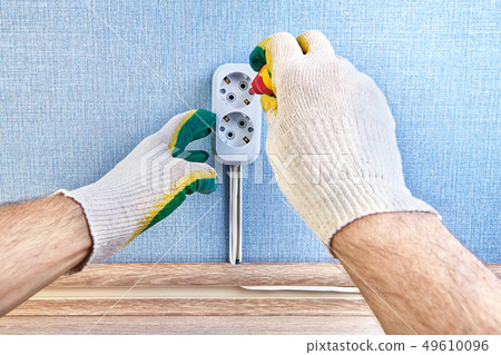 Worker changes pattress box of electrical outlet. Worker changes pattress box of electrical outlet. 49610096