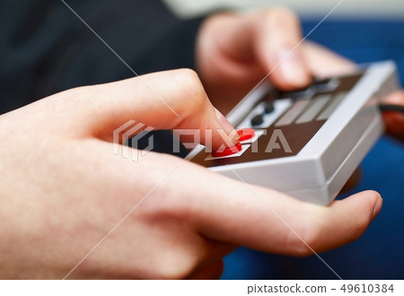 Playing an old gaming console 49610384