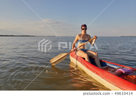 Canoeing on a lake 49610414