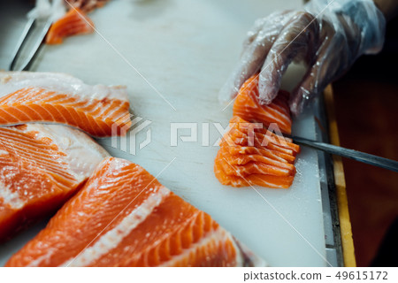 Asian chef slice japanese food sashimi salmon Asian chef slice japanese food sashimi salmon 49615172