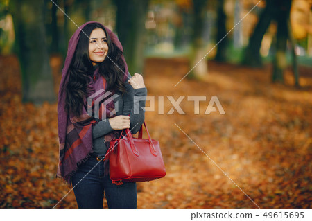 brunette girl relaxing at the park 49615695