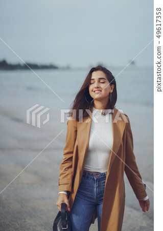 young girl walking on the beach young girl walking on the beach 49617358