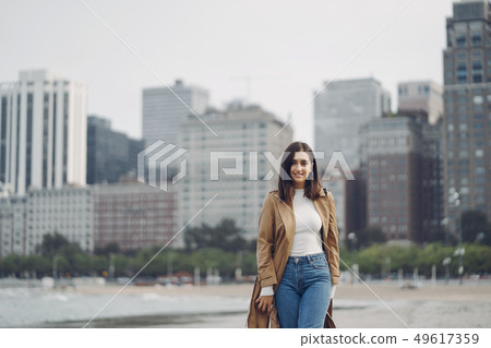 young girl walking on the beach young girl walking on the beach 49617359