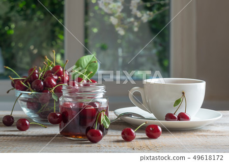Tea and cherry jam on a wooden table 49618172
