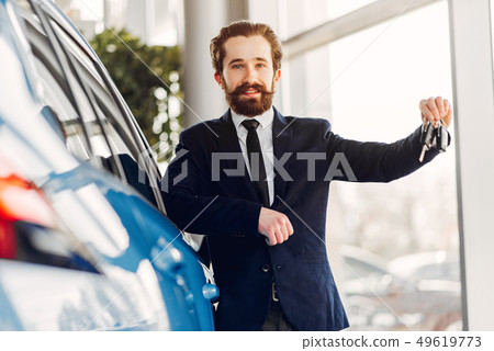 Handsome and elegant man in a car salon 49619773
