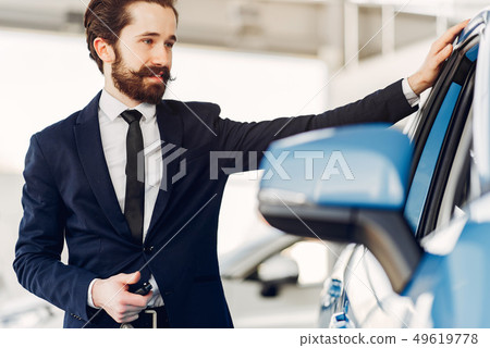 Handsome and elegant man in a car salon Handsome and elegant man in a car salon 49619778