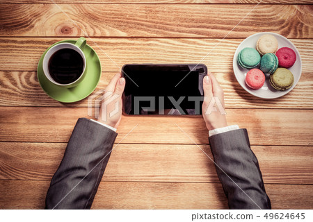 Businesswoman having coffee break Businesswoman having coffee break 49624645