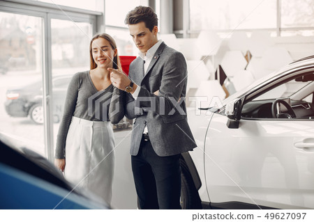Elegant couple in a car salon Elegant couple in a car salon 49627097