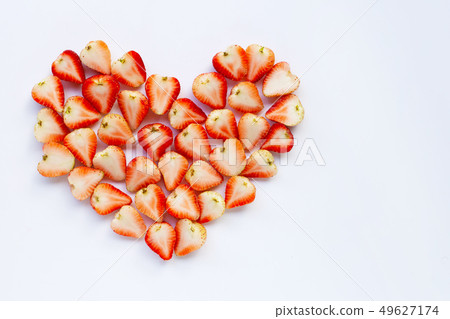 Strawberries positioned in a heart shape on white. 49627174