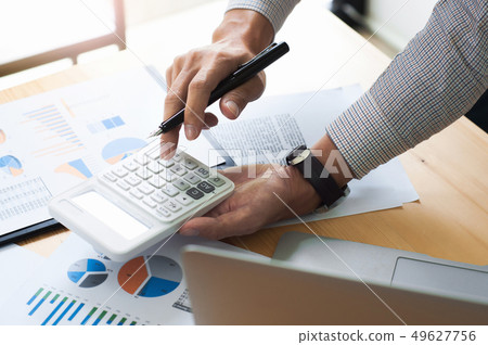Business man analysis investment perform data document and calcu Business man analysis investment perform data document and calcu 49627756