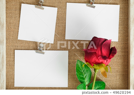 empty white love card with rose on wooden texture board backgrou 49628194