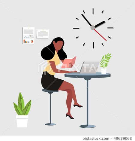woman reading a book with computer workspace 49629068