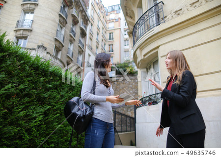 Jocund girl paying Chinese teacher with card and tablet for less Jocund girl paying Chinese teacher with card and tablet for less 49635746