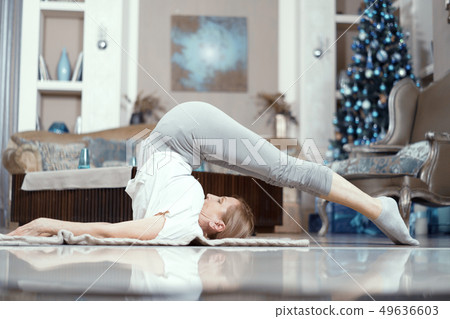 Charming woman lays on her back stretching 49636603