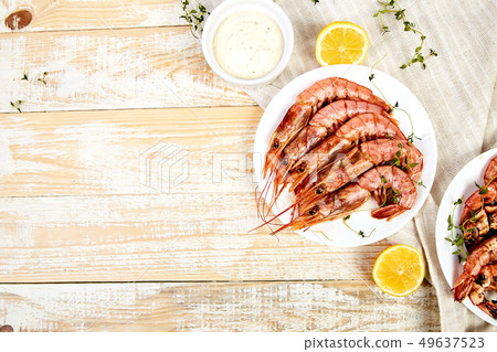 Grilled big tiger shrimps prawns on white plate Grilled big tiger shrimps prawns on white plate 49637523
