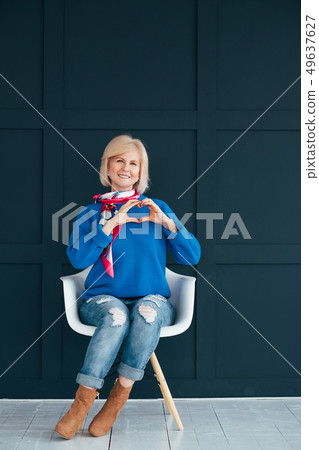 stylish senior woman heart shape hand care 49637627