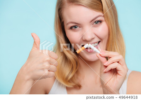 Smilling girl is breaking cigarette 49644918