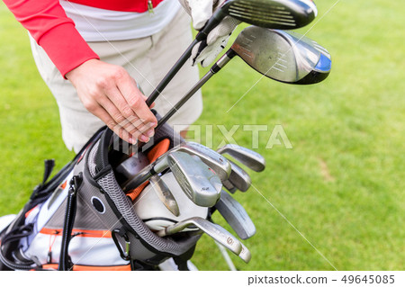Golfer choosing best club in bag 49645085