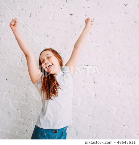 Happy teenager girl on the white background of the 49645611