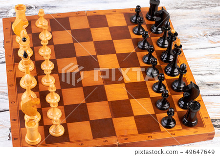 Wooden chess pieces placed on chess board. Wooden chess pieces placed on chess board. 49647649