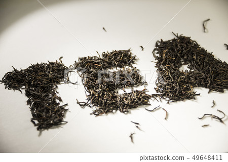 inscription tea from black tea leaves on a white background 49648411