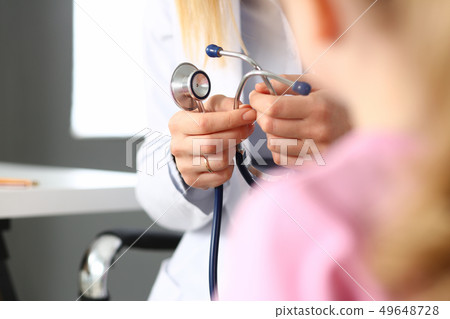 Female doctor arm hold stethoscope measuring patient heartbeat 49648728
