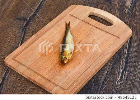 Baltic herring cold smoked on a wooden board Baltic herring cold smoked on a wooden board 49649123