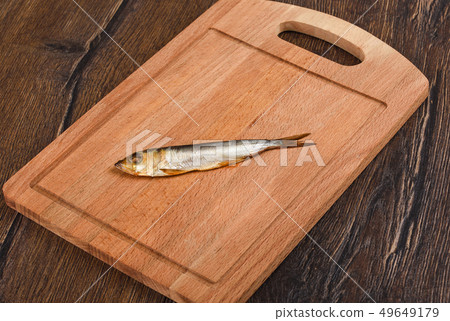 Baltic herring cold smoked on a wooden board Baltic herring cold smoked on a wooden board 49649179