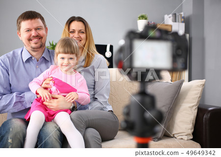 Young happy family sit on couch making photo session portrait Young happy family sit on couch making photo session portrait 49649342