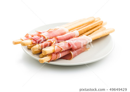 Parma ham prosciutto with grissini breadsticks. Parma ham prosciutto with grissini breadsticks. 49649429