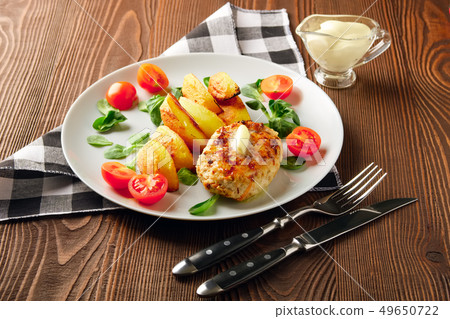 Fried chicken cutlet with roasted potato slices Fried chicken cutlet with roasted potato slices 49650722