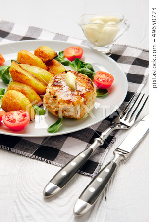 Fried chicken cutlet with roasted potato slices  49650723