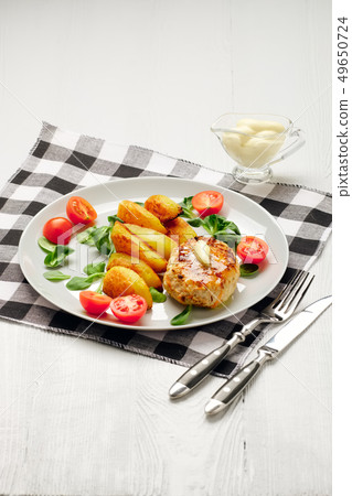 Fried chicken cutlet with roasted potato slices Fried chicken cutlet with roasted potato slices 49650724