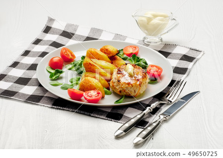 Fried chicken cutlet with roasted potato slices Fried chicken cutlet with roasted potato slices 49650725