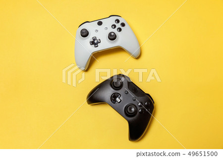 White and black two joystick on yellow background. 49651500