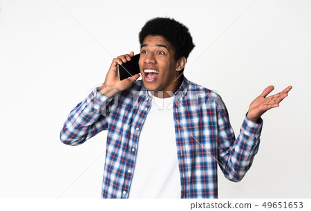 Unexpected call. Surprised guy talking on phone Unexpected call. Surprised guy talking on phone 49651653