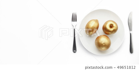Golden fruits served on plate 49651812