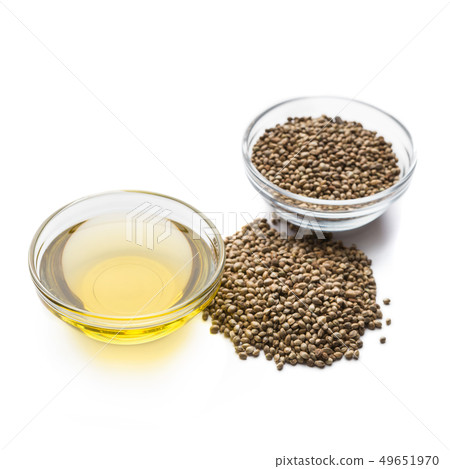 Hemp oil and seeds in bowls on white Hemp oil and seeds in bowls on white 49651970