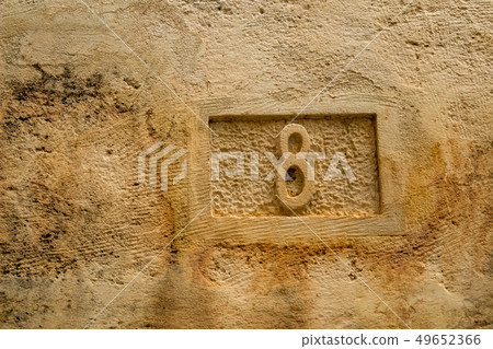 Number eight, 8, carved in yellow limestone Number eight, 8, carved in yellow limestone 49652366