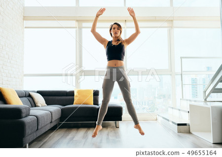 Adult Woman Training Legs Doing Squat and Jumping Adult Woman Training Legs Doing Squat and Jumping 49655164