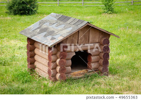 Wooden dog house  on green lawn. 49655363