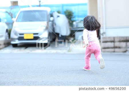 Toddler playing outside Toddler playing outside 49656200
